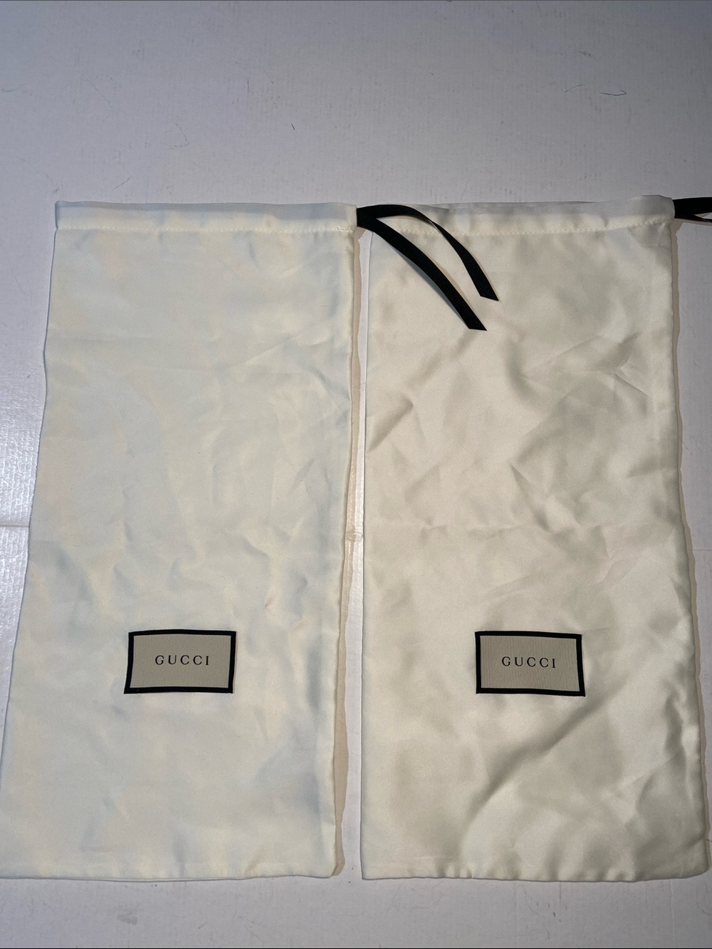 Pair of Authentic ivory satin Gucci shoe and accessory dusts
